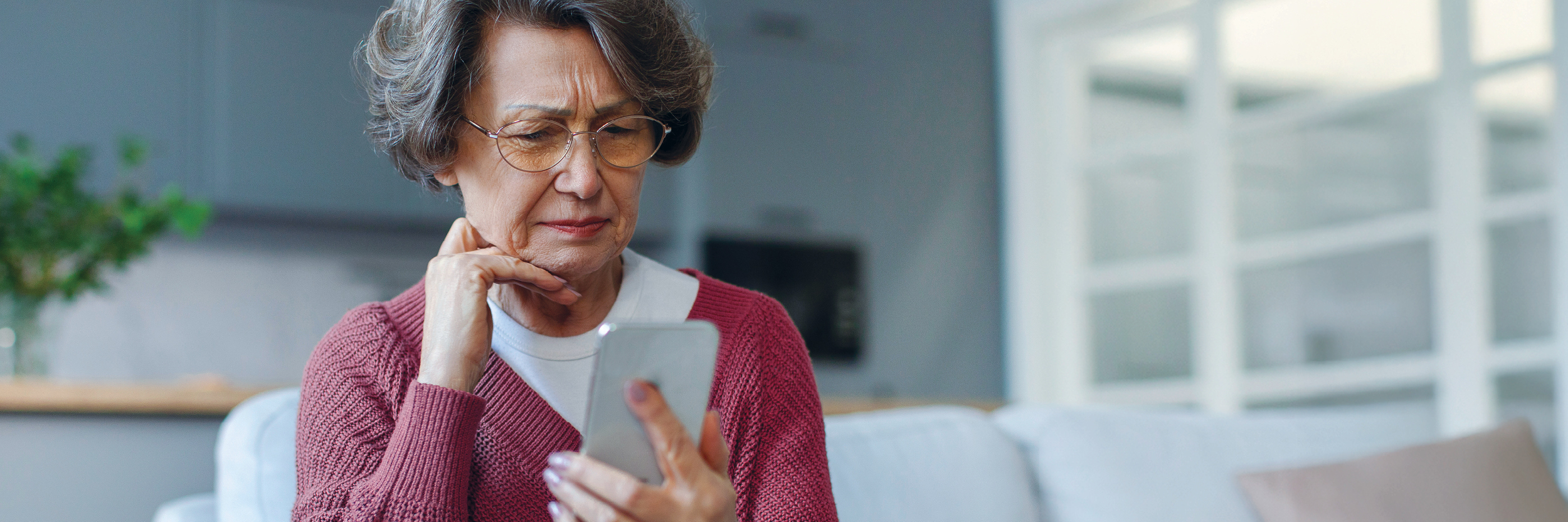 Bank customer looking at scam on phone