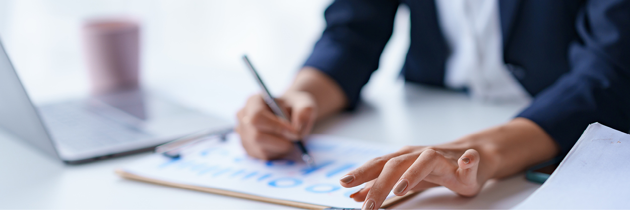 A woman's hands are seen as she writes on a graph