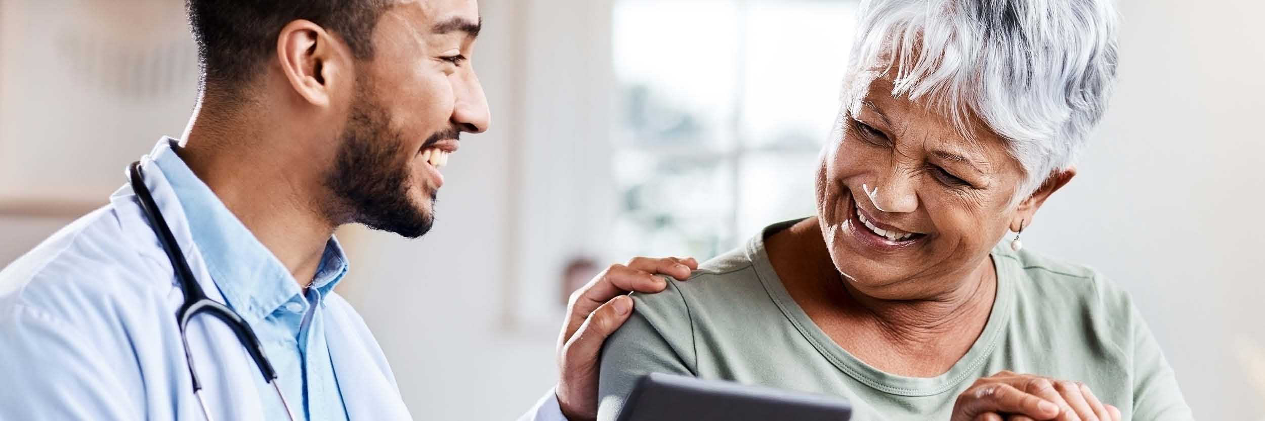 A doctor talks to a patient as they look at a chart.ooke