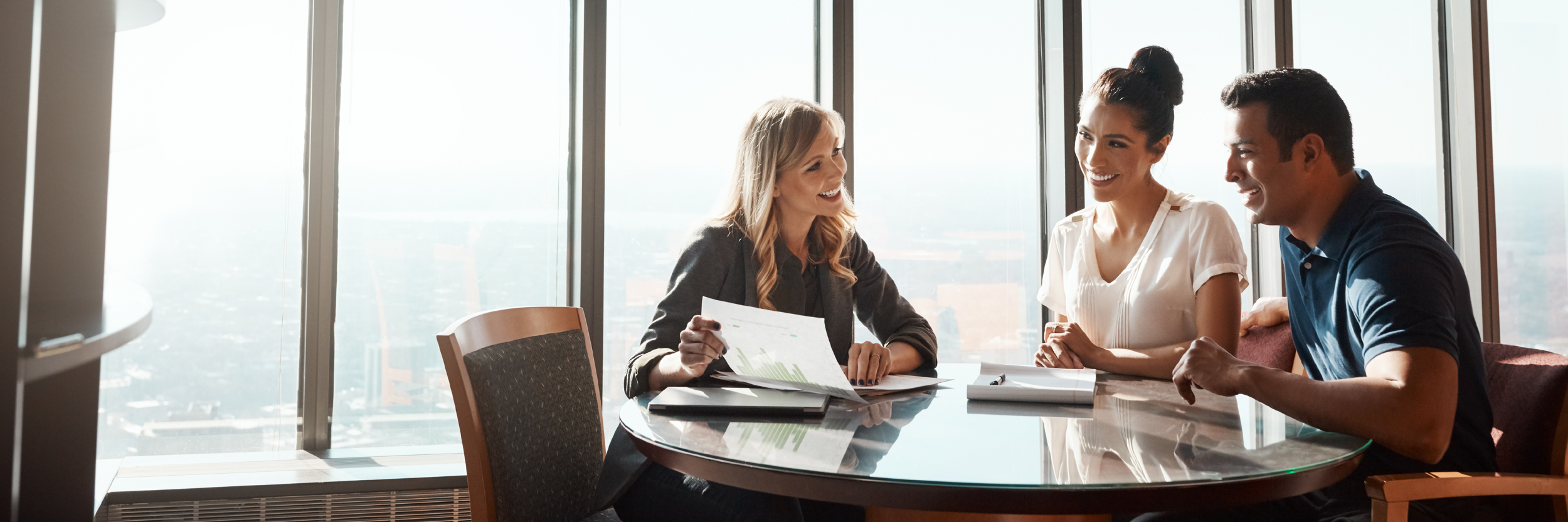 A man and woman sit at a table with a woman advisor.