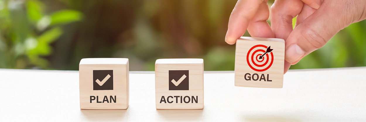 3 wooden blocks with plan, action and goal written on them