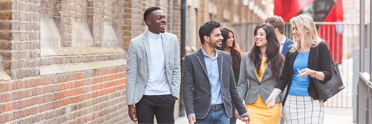 A group of young adults walk together.