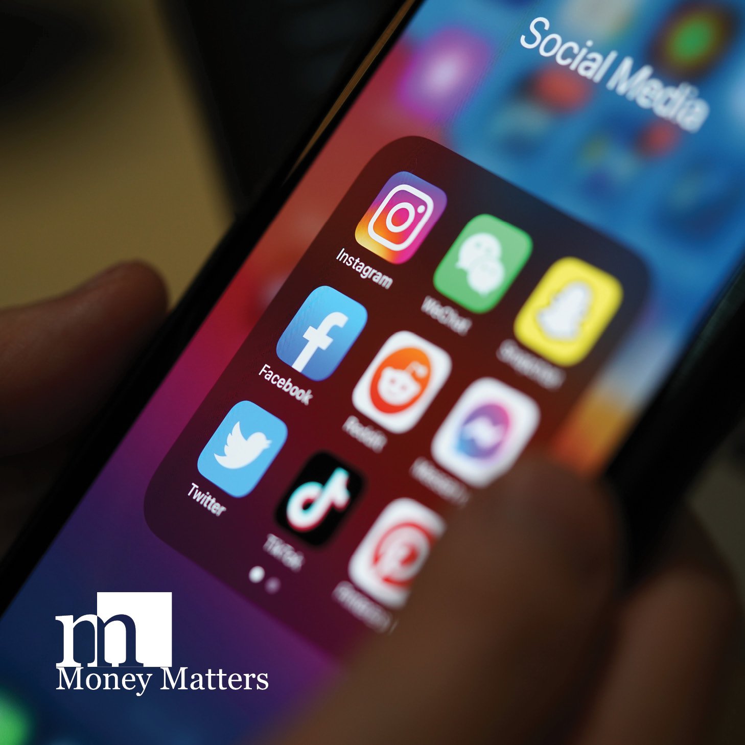 A photo of a phone showing social media apps