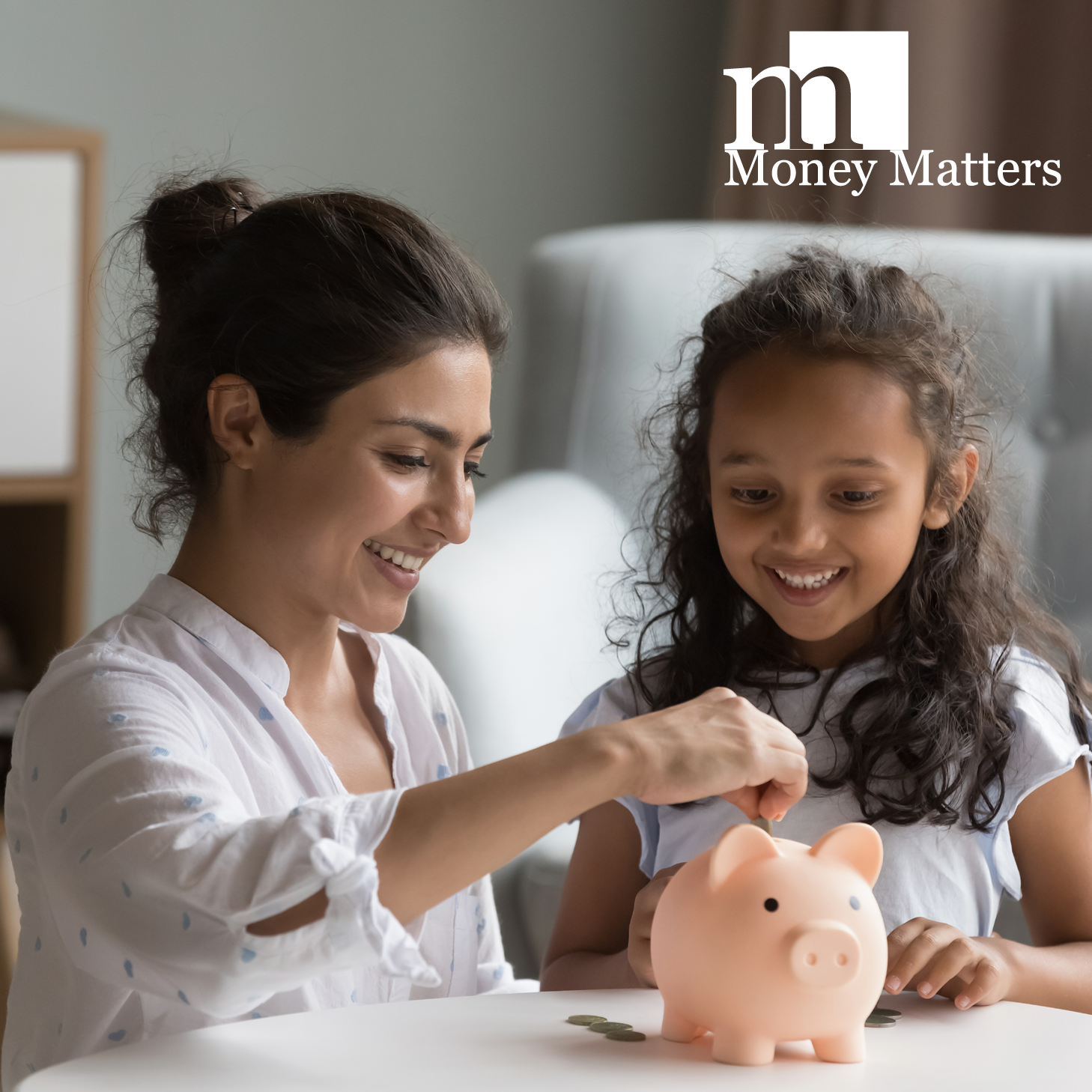 A woman and a girl put money into a piggy bank.