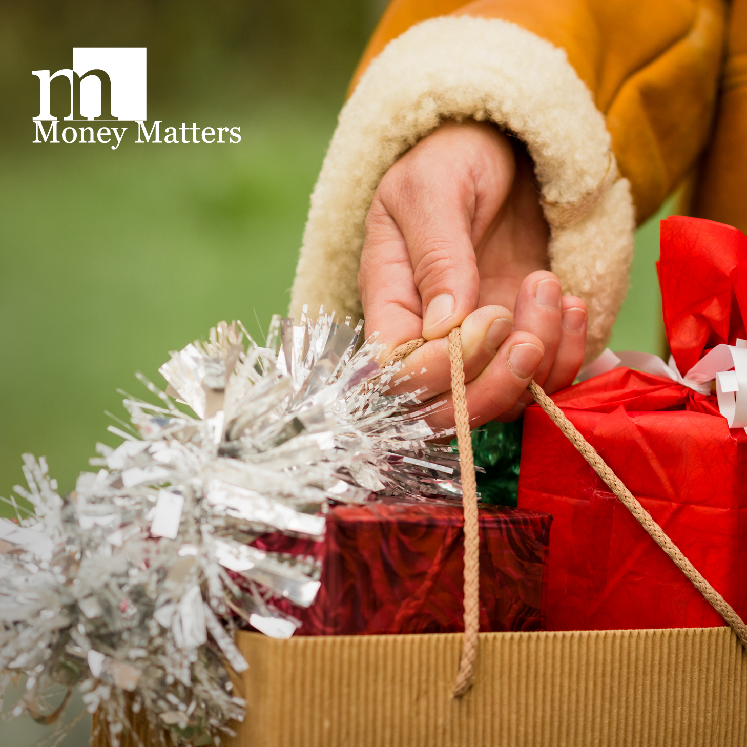 A person's hand is shown, holding a bag of gifts.